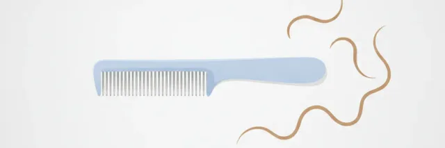 A fine-toothed nit comb resting beside a few strands of hair on a plain light surface, calm and clinical, no people.