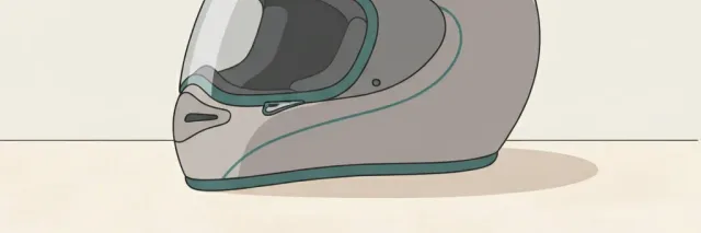 A single empty motorcycle helmet resting on a pale surface, flat vector illustration in muted greys.