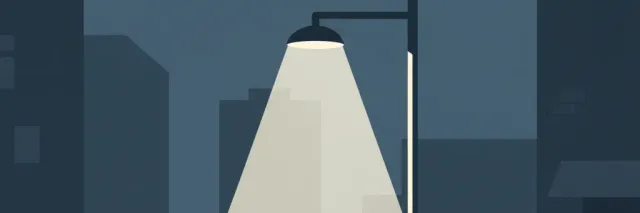 A single streetlight casting a pale cone of light on an empty sidewalk, flat vector illustration in muted dark blues and greys.